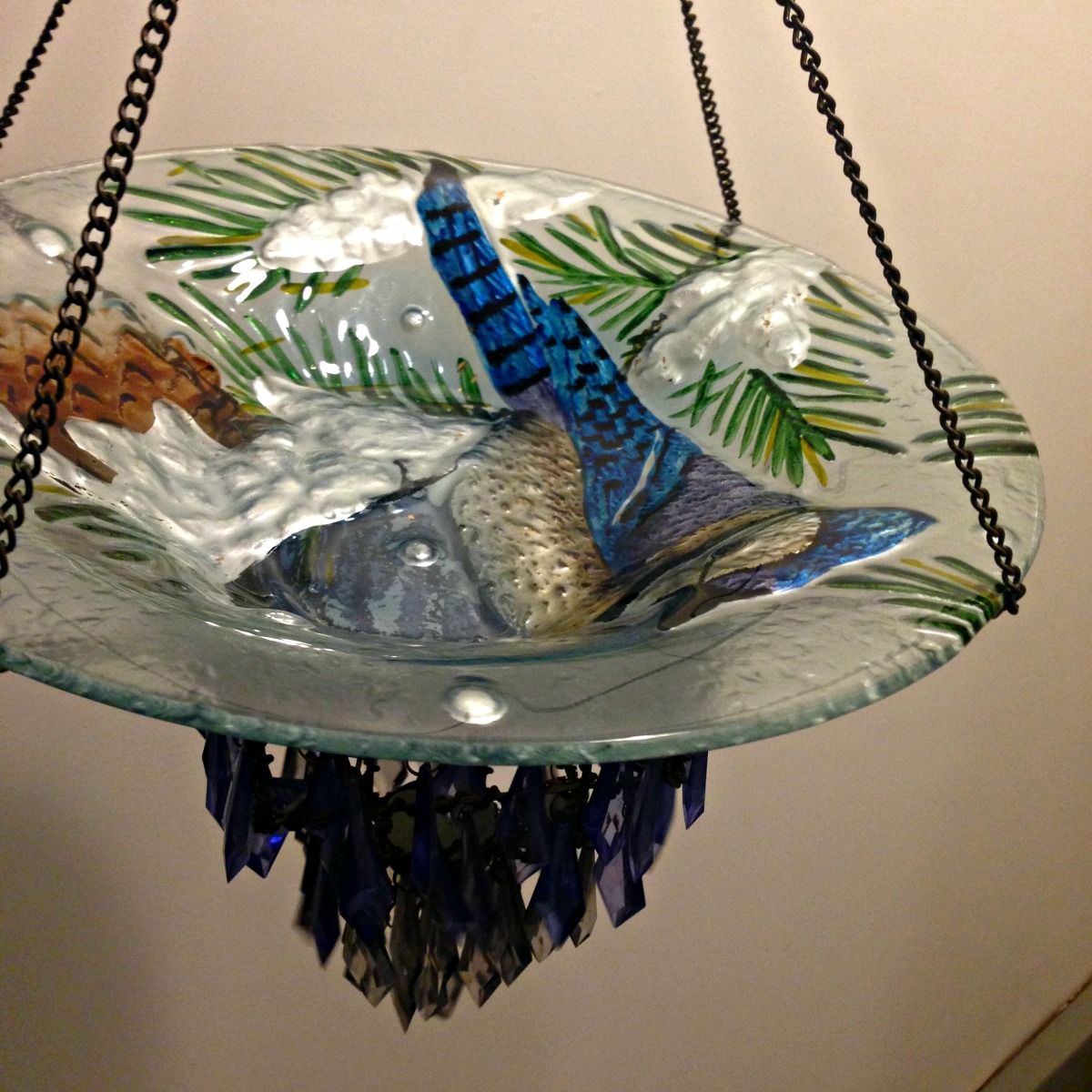 DIY Blue Jay Bird Bath and Bird Feeder made with repurposed vase and hanging crystal candle holder from Thrift Store