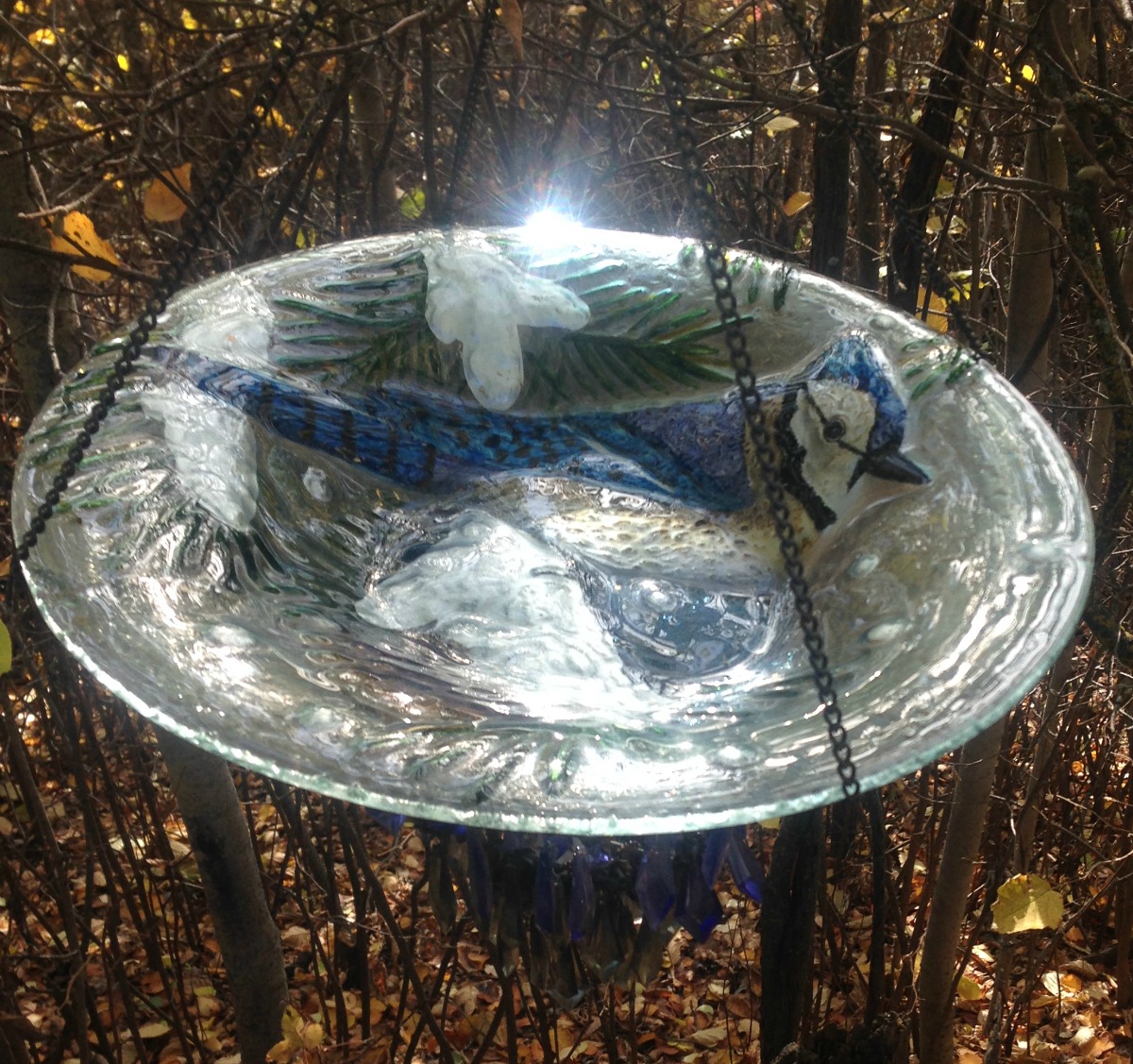 DIY Blue Jay Bird Bath and Bird Feeder made with repurposed vase and hanging crystal candle holder from Thrift Store