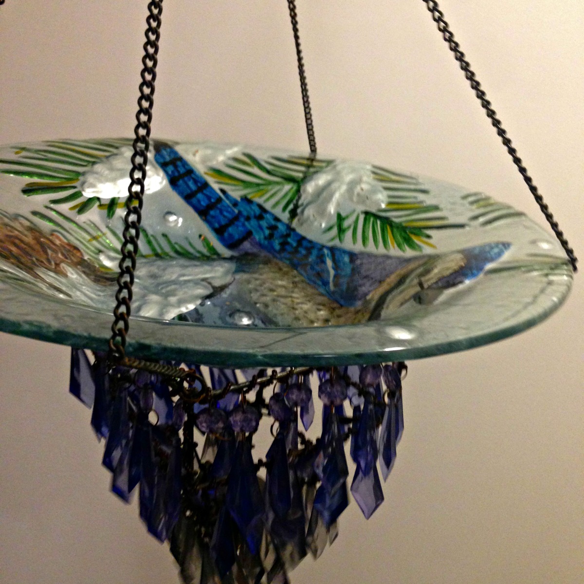 DIY Blue Jay Bird Bath and Bird Feeder made with repurposed vase and hanging crystal candle holder from Thrift Store